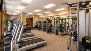 A gym with treadmills, weight machines, and a mirrored wall. - Tamarack Resort Village Ski In Ski Out Condo - Year Round Resort (Donnelly)