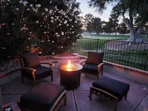 An outdoor seating area with a fire pit, two chairs, and a bench. - Beautiful home on the 8th hole of LV Country Club! (Las Vegas)
