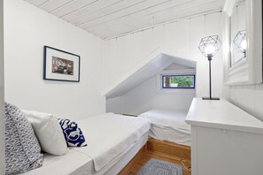 A bedroom with a loft bed, a framed picture on the wall, and a window with a view of greenery. - Highland Lake Cottage/Waterfront/Dock/Kayaks (Windham)