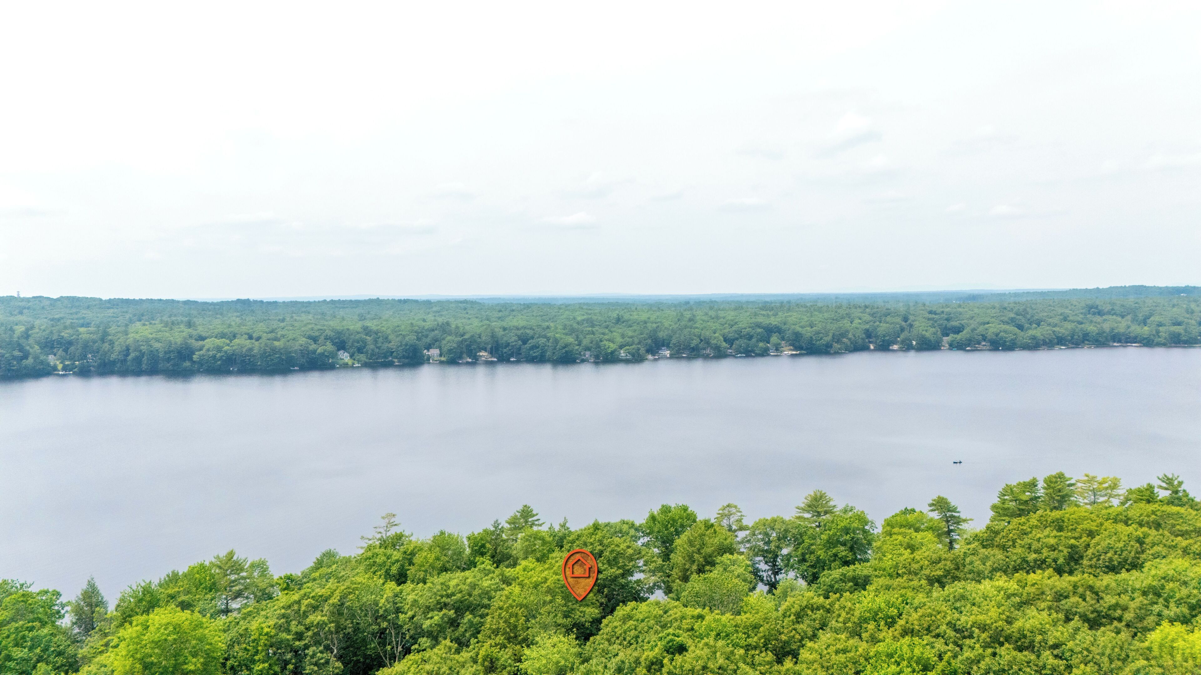 A lake surrounded by dense forest with a clear view of the water.