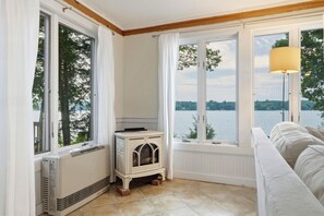 A room with a view of a lake, a radiator, and a white radiator cover. - Highland Lake Cottage/Waterfront/Dock/Kayaks (Windham)