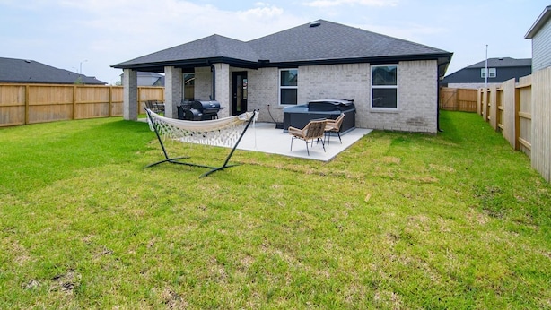A residential house with a patio, outdoor seating, and a hot tub. -     Spacious Katy TX  one story Home / 4 Bedrooms + Hot Tub (Katy)