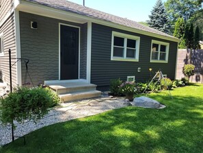 A residential house with a front porch, steps, a small garden, and a gravel pathway. - The Nature Preserve in Portsmouth (Portsmouth)