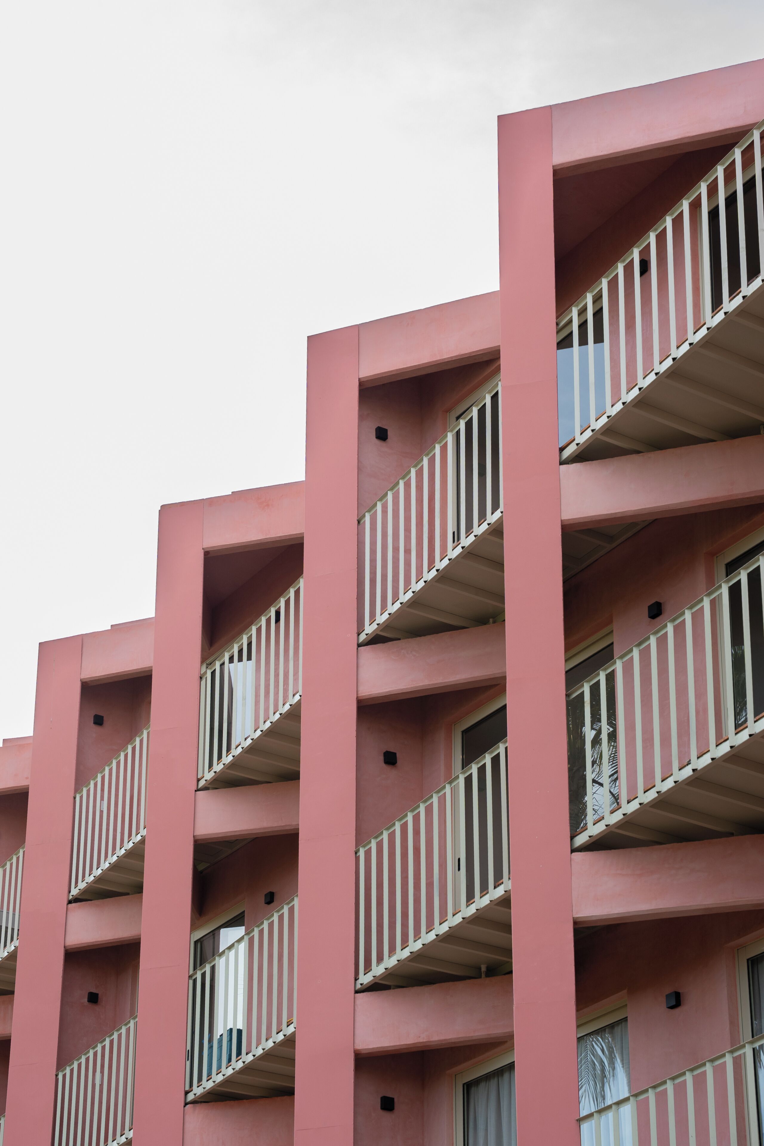 A multi-story building with balconies and windows.