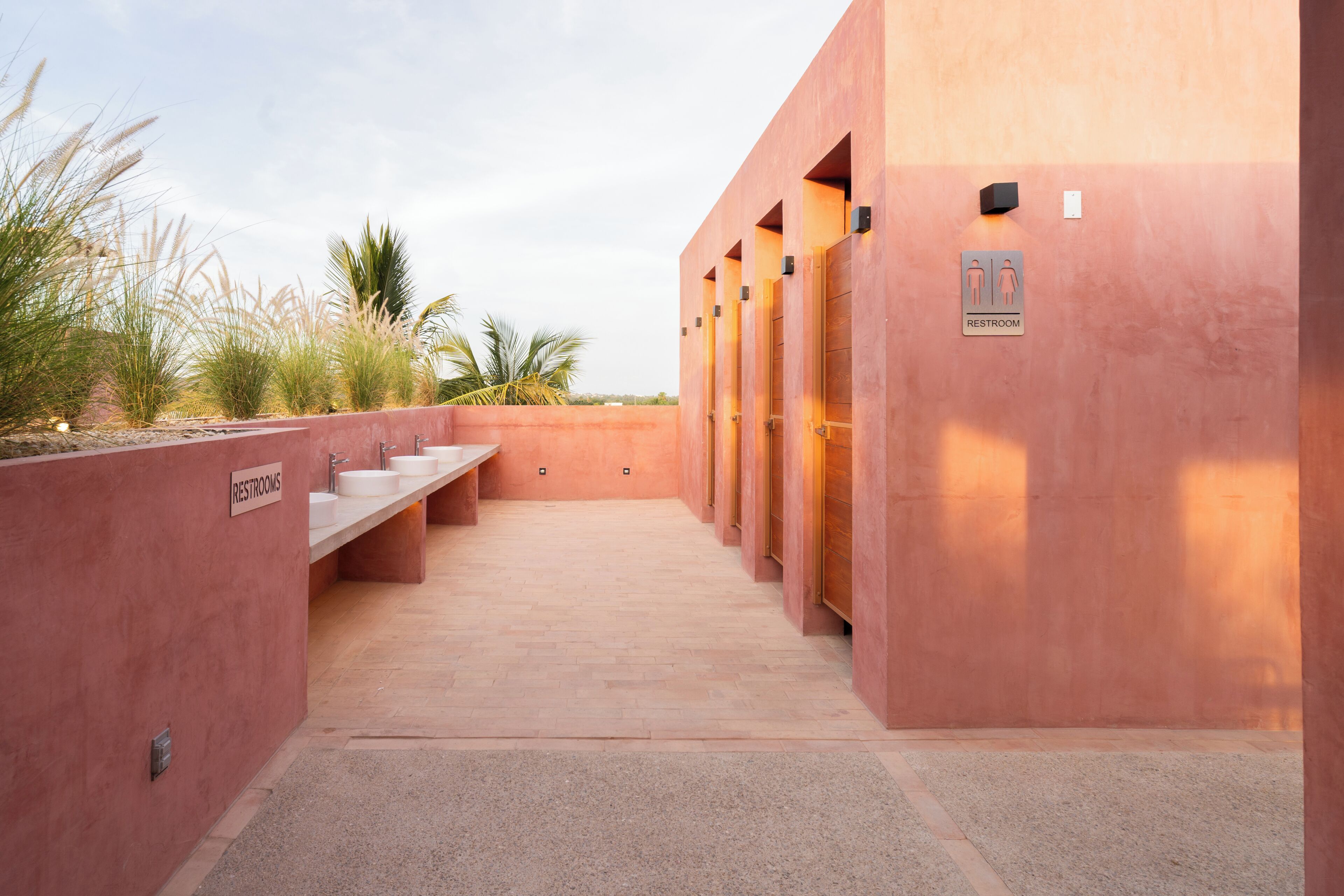 A row of restrooms with a sign indicating gender-specific facilities.