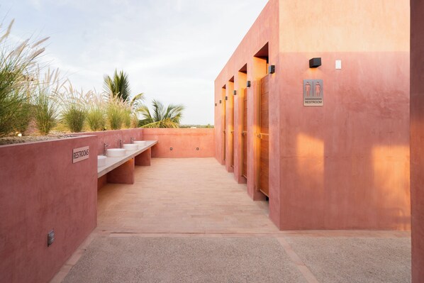 A row of restrooms with a sign indicating gender-specific facilities.