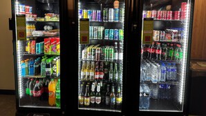 Three beverage vending machines with various drink options. - Studio com sacada próximo à Paulista (São Paulo)