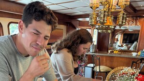 A dining area with a marble countertop, seafood dishes, and a vase with flowers. - Why knot YACHT!!!! Luxury king accommodation on the dock with breakfast included (Ketchikan)