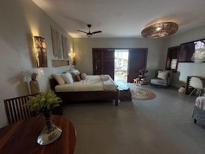 A modern living room with a bed, seating area, and a dining table. - refugio prea (Cruz)