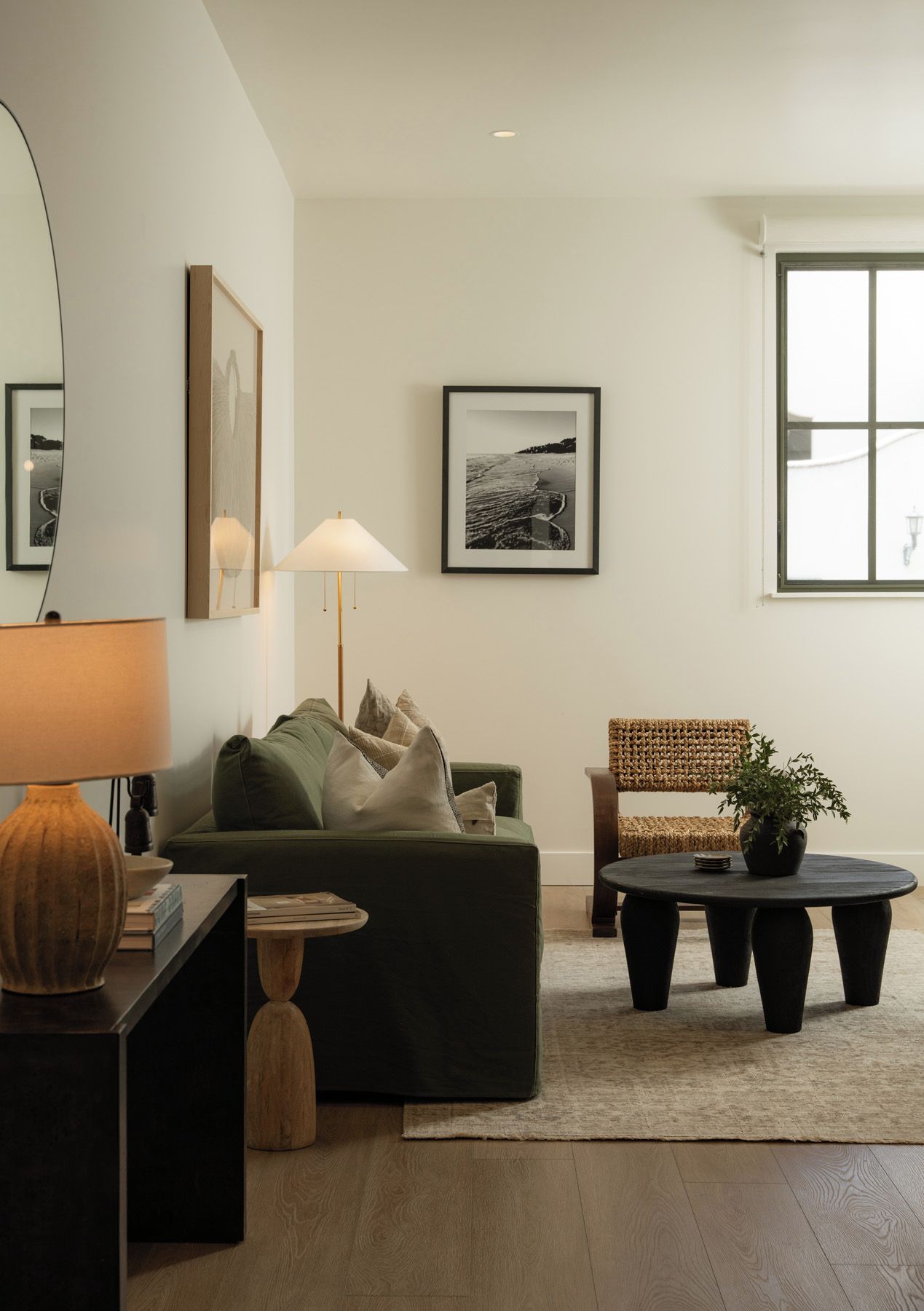 A modern living room with a sofa, a coffee table, a lamp, and a chair.