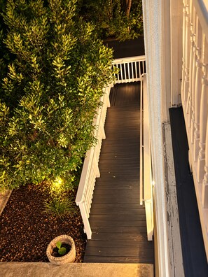 A wooden staircase with a white railing leading up to a door. - Downtown Mansion 10 bedrooms/7.5 baths, 34+ people, 11car gated parking, Jacuzzi (San Antonio)