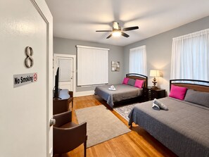 A hotel room with two beds, a ceiling fan, a TV, and a 'No Smoking' sign. - Downtown Mansion 10 bedrooms/7.5 baths, 34+ people, 11car gated parking, Jacuzzi (San Antonio)