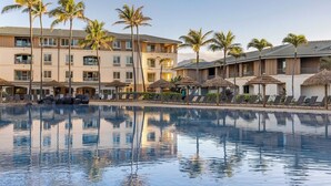 A hotel with a swimming pool, palm trees, and lounge chairs. - Spend Thanksgiving 2026 in Paradise! 2BR/2BA condo at The Point at Poipu (Koloa)