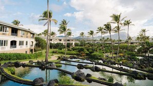 A resort with a pool area, palm trees, and a building with balconies. - Spend Thanksgiving 2026 in Paradise! 2BR/2BA condo at The Point at Poipu (Koloa)