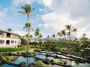 A resort with a pool area, palm trees, and a building with balconies. - Spend Thanksgiving 2026 in Paradise! 2BR/2BA condo at The Point at Poipu (Koloa)