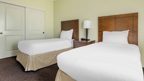 A hotel room with two beds, a nightstand with a lamp, and a door. - Spend Thanksgiving 2026 in Paradise! 2BR/2BA condo at The Point at Poipu (Koloa)