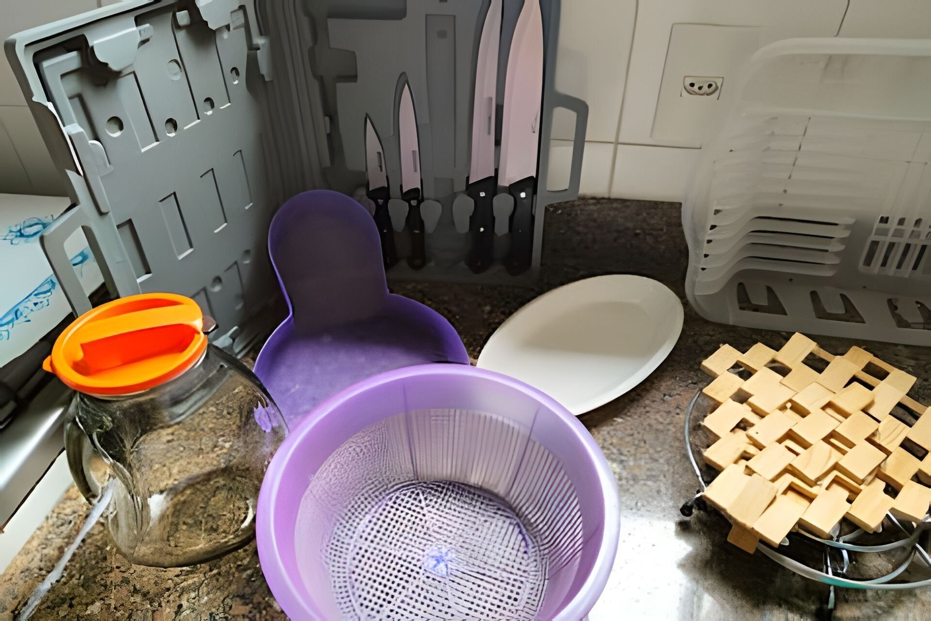 A kitchen with a purple chair, a white plate, a colander, and a woven basket.