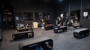 A gym with various exercise equipment including TRIFORM benches and kettlebells. - real village roma (Roma)