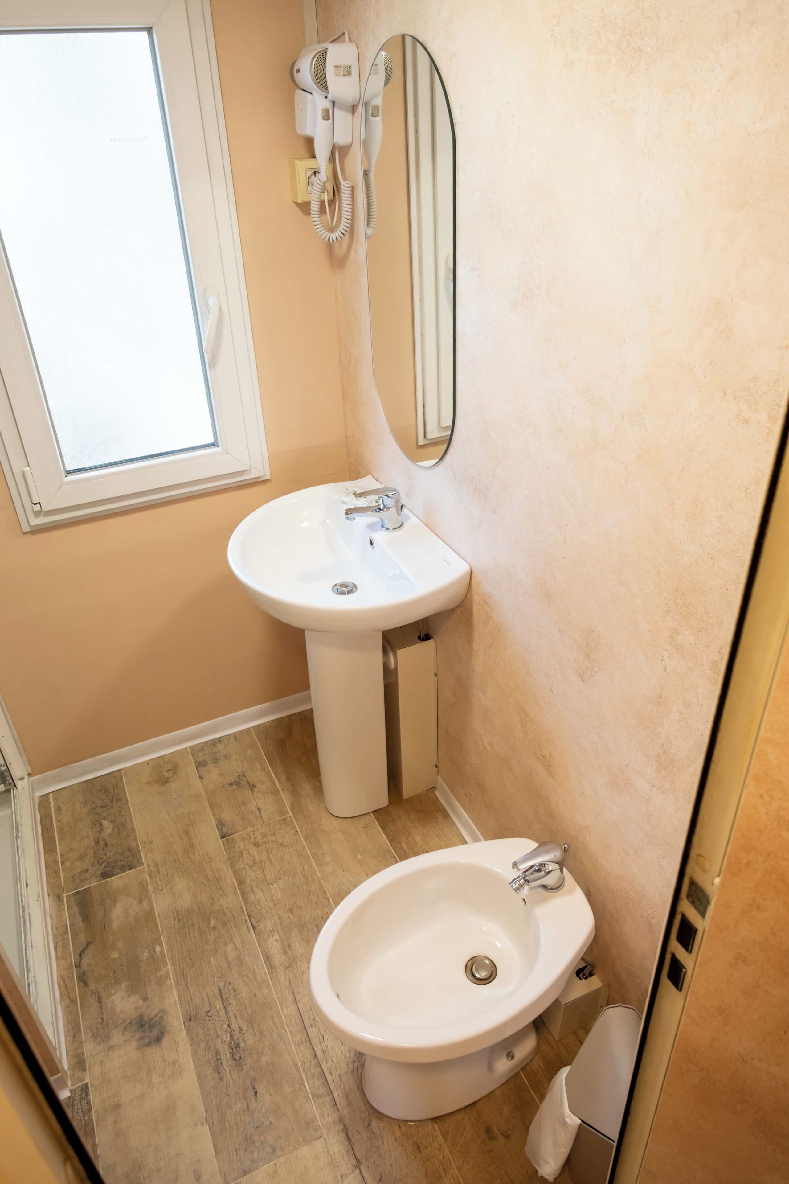 A bathroom with a sink, a mirror, and a toilet.