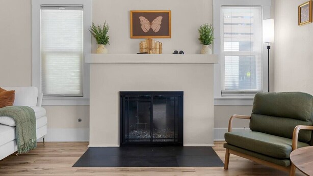A living room with a fireplace, a sofa, a chair, and a side table. - Mission Hills retreat, walkable, free parking (San Diego)