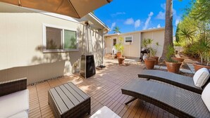 A patio area with outdoor furniture, a heater, and potted plants. - Mission Hills retreat, walkable, free parking (San Diego)