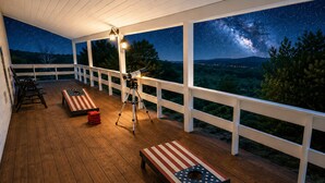 A covered outdoor deck with a telescope, benches, and a starry night view. - 200 Acre Retreat, Family Friendly, Stargazing, More (Hesperus)