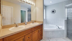 A bathroom with two sinks, a large mirror with lights, a bathtub, and a shower. - Private Pool Villa 5BR  (Davenport)