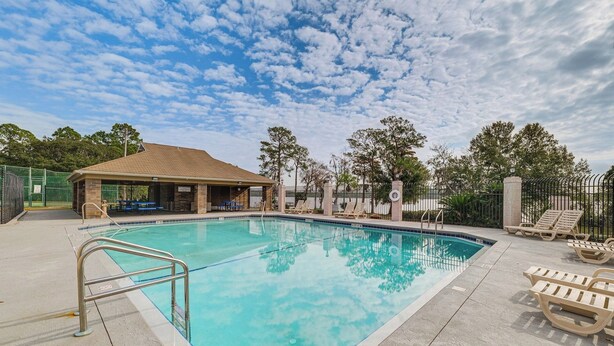 A swimming pool with a fenced deck area, lounge chairs, and a covered pavilion. - Private Pool Villa 5BR  (Davenport)
