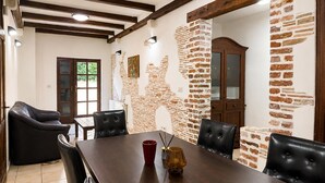 A dining area with a wooden table, black leather chairs, a red cup, and a candle. - Awesome home in Porec (Porec)