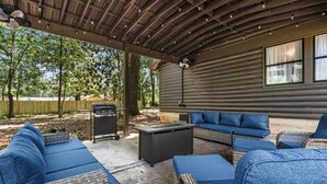An outdoor patio with wicker furniture, a grill, and a covered area with a ceiling fan. - First Cast Foley - Fully Renovated Barn Home (Foley)