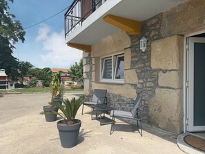 A two-story building with a balcony, stone walls, and a door. - La Graciosa Apartment 2033 (San Miguel de Meruelo)