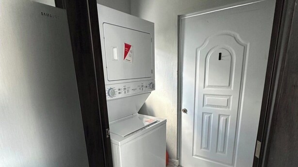 A laundry room with a white washing machine, a dryer, and a Samsung refrigerator. - Spacious 4-bedroom townhome in lovely Punta Cana with AC and free WiFi (Punta Cana)