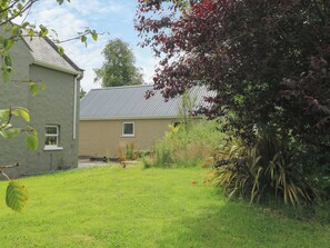 A house with a sloped roof and a small front yard.