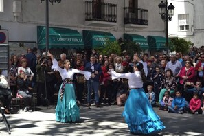 A street performance with dancers in traditional attire.
