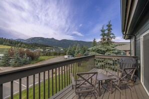 A wooden deck with a view of mountains and a road. - New Listing! Explore Big Sky, Hike + Ski (Big Sky)