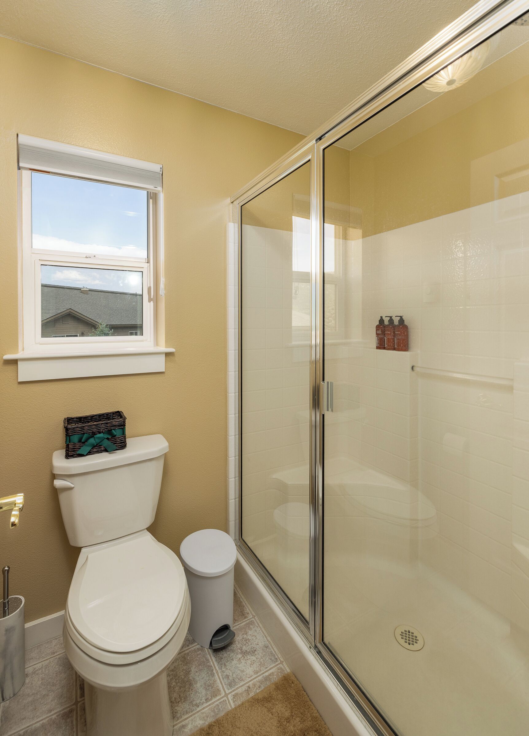 Een badkamer met toilet, bidet en douchecabine met glazen wanden.