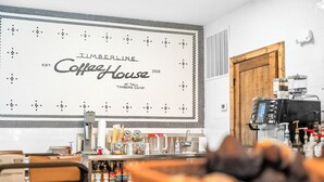 A coffee shop interior with a large sign reading 'Timberline CoffeeHouse 2026' and a coffee machine. - Rustic Log Cabin, 1-Min Walk to Lazy River — Hot Tub, Sleeps 6, Resort Pools (Hollister)