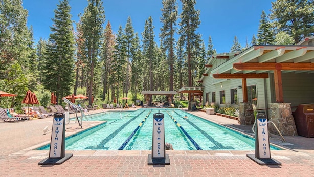 A swimming pool with lane markers and a pavilion in a forested area. - The Nest at Northstar by Tahoe Getaways - 3BR Walk to Northstar w HOA & Ski Shuttle! (Truckee)