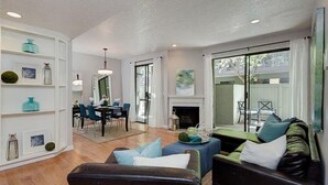 A living room with a fireplace, a dining area, and a sofa. - Heart of Pasadena - Walkable/Bikeable to hospitals, Old Town and Caltech/PCC (Pasadena)
