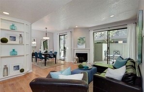 A living room with a fireplace, a dining area, and a sofa. - Heart of Pasadena - Walkable/Bikeable to hospitals, Old Town and Caltech/PCC (Pasadena)