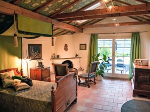 A cozy room with a bed, a chair, a desk, and a window with curtains. - Bolzbach mit Seeanstoss by Interhome (Altdorf UR)