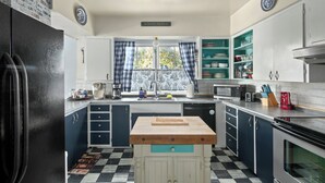 A kitchen with a central island, a sink, a microwave, and a stove. - Fire Pit Backyard, Walk to Town, Close to Glacier, Whitefish,Ski Hill, Northfork (Columbia Falls)