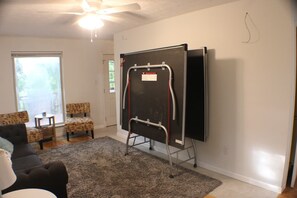 A room with a large blackboard on a stand, a ceiling fan, and two patterned chairs. - Cub Run Lake House Retreat - Nolin Lake (Cub Run)