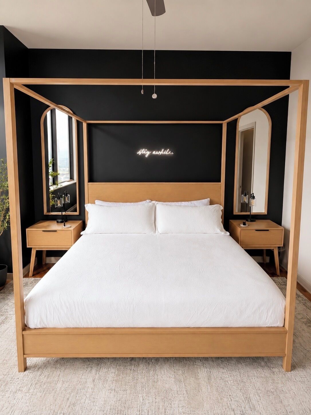 A modern bedroom with a wooden four-poster bed, two bedside tables, a large mirror, and a neon sign on the wall.