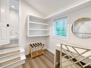 A room with white walls, a window with blinds, a door, a set of stairs, and a small wooden rack. - 2 Golf Carts☀️ On Raven Golf Course | Heated Pool | Hot Tub | Gym | Beach Gear ☀️Sandestin (Miramar Beach)