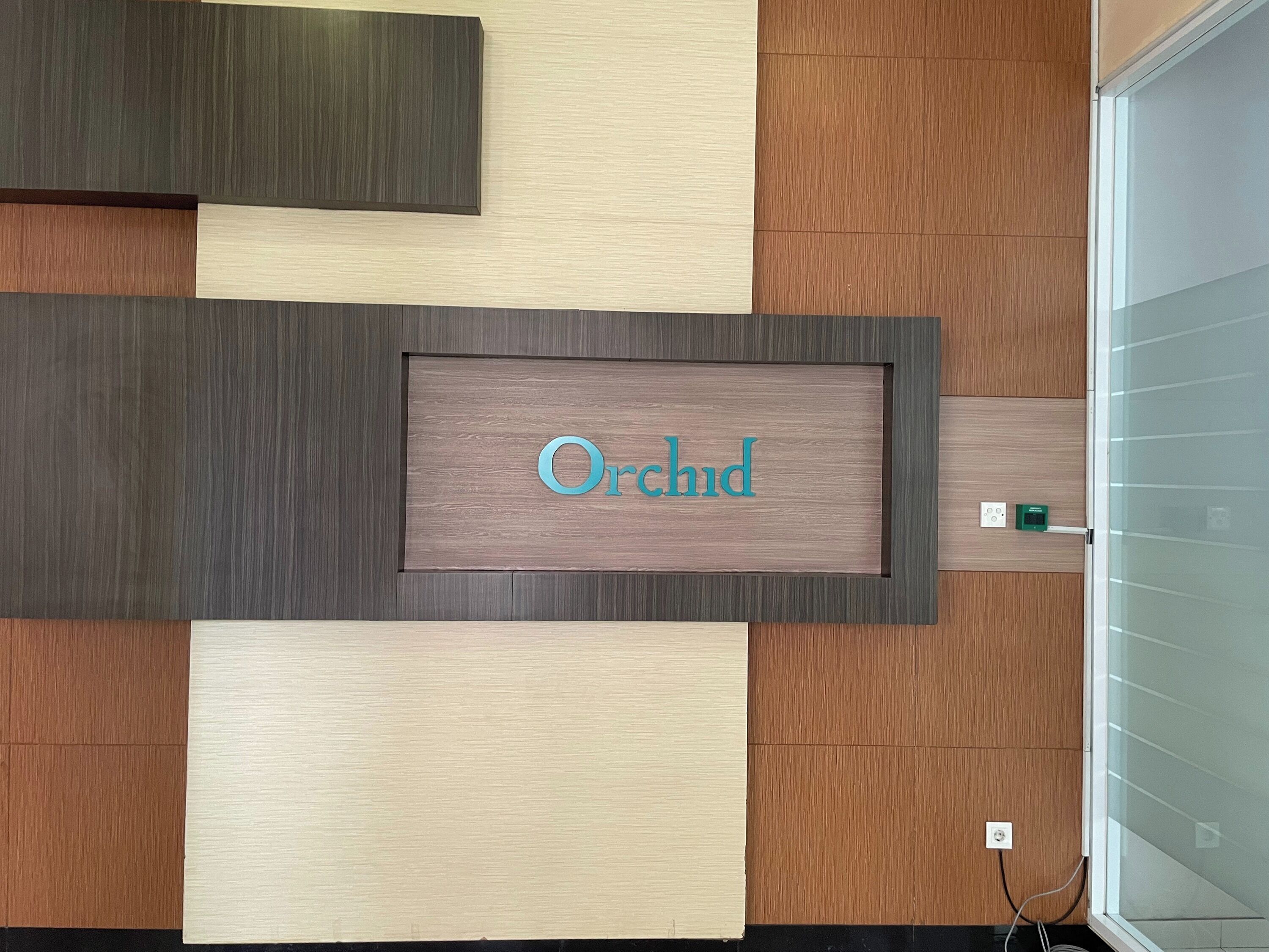 A wall with a nameplate reading 'Orchid' and a modern, geometric design.