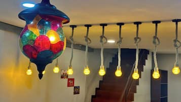 A staircase with a hanging light fixture above it.