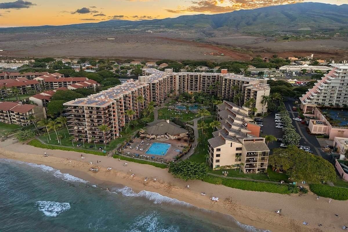 A coastal resort with multiple high-rise buildings, a beachfront, and a swimming pool.