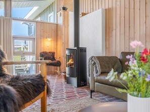 A cozy interior with a fireplace, wooden walls, and a comfortable seating area. - "Elsamaria" - 400m from the sea by Interhome (Blokhus)