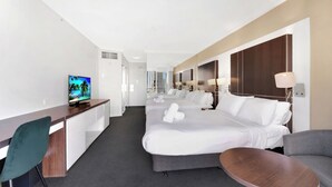 A hotel room with a bed, a desk, a chair, a TV, and a small table. - Cozy 2 Double-bed Hotel Room | Max 4 guests (Surfers Paradise)